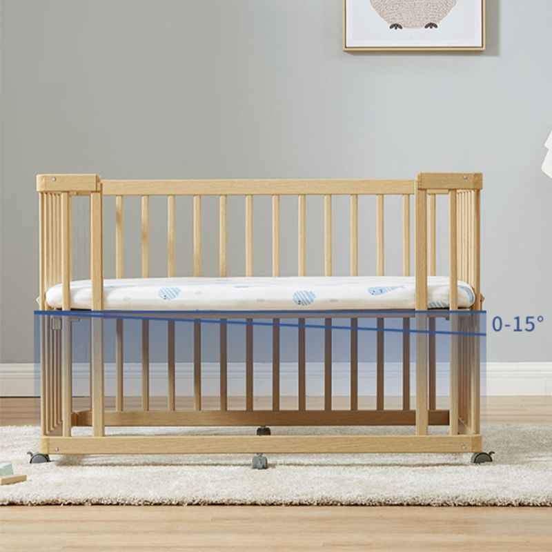 Contemporary 25.19" Wide Wooden Nursery Bed in Natural with Wheels