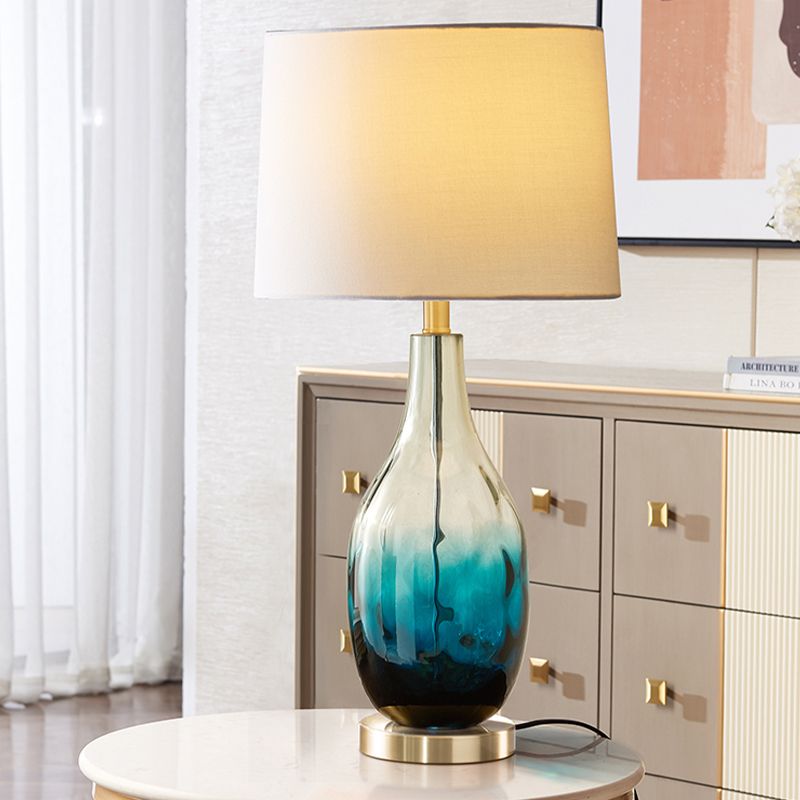 Beige/Brown 1 Head Nightstand Lamp Contemporary Fabric Drum Table Lighting with Jar Fading Blue Glass Base