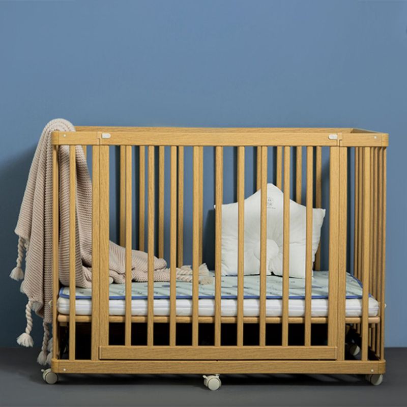 Contemporary 25.19" Wide Wooden Nursery Bed in Natural with Wheels