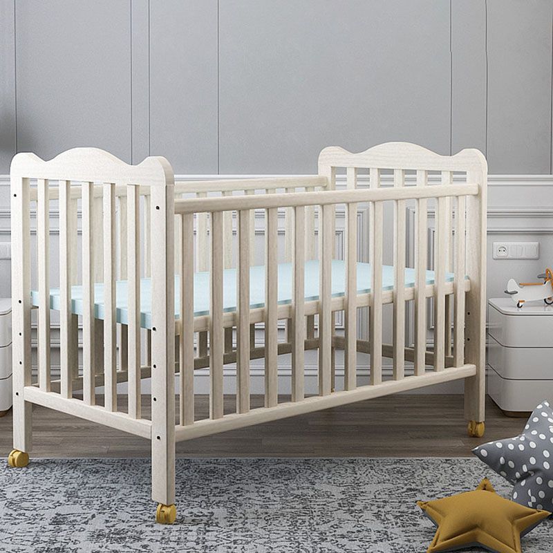 Farmhouse Wooden Baby Crib with Guardrail and Casters in Pine Wood