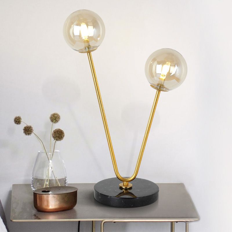 2 Bulbs Bedroom Table Light Post-Modern Black and Gold Night Lamp with Dual Ball Amber Glass Shade