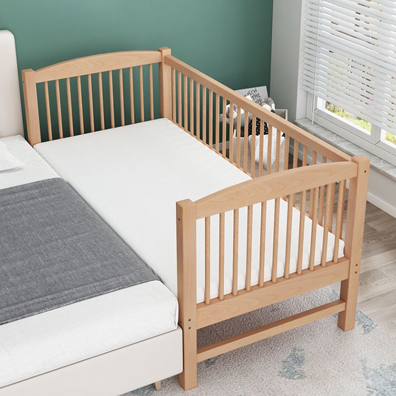 Functional Nursery Crib with Adjustable Height in Natural Wood