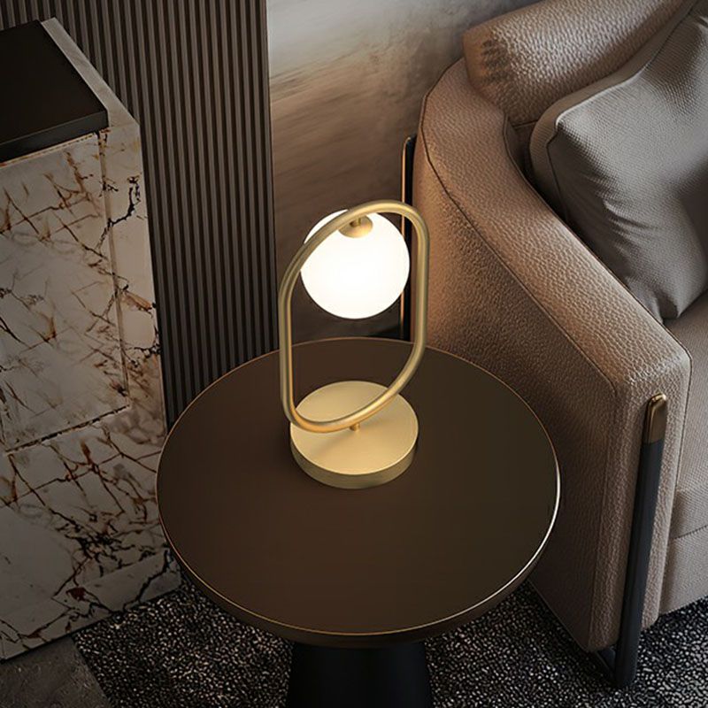 Minimalist Oval Frame Table Lighting Metal 1-Head Bedroom Night Light with Ball Milk Glass Shade in Gold