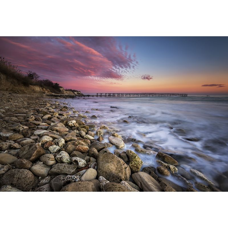 Pink-Blue Tropix Mural Full Size Rock Seashore with Distant Bridge at Dusk Wall Decor for Bedroom