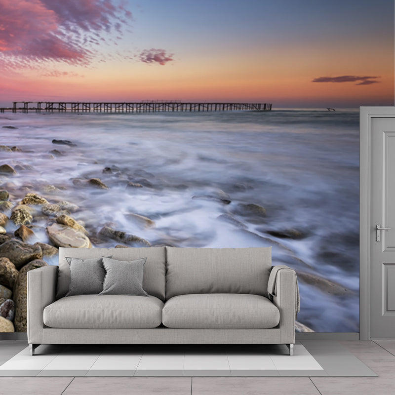 Pink-Blue Tropix Mural Full Size Rock Seashore with Distant Bridge at Dusk Wall Decor for Bedroom